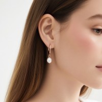 Natural freshwater pearl teardrop earrings, available in gold, silver, and rose gold.